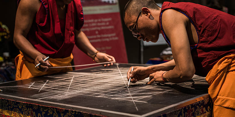 The Tibetan Monks making the template for the sand mandala