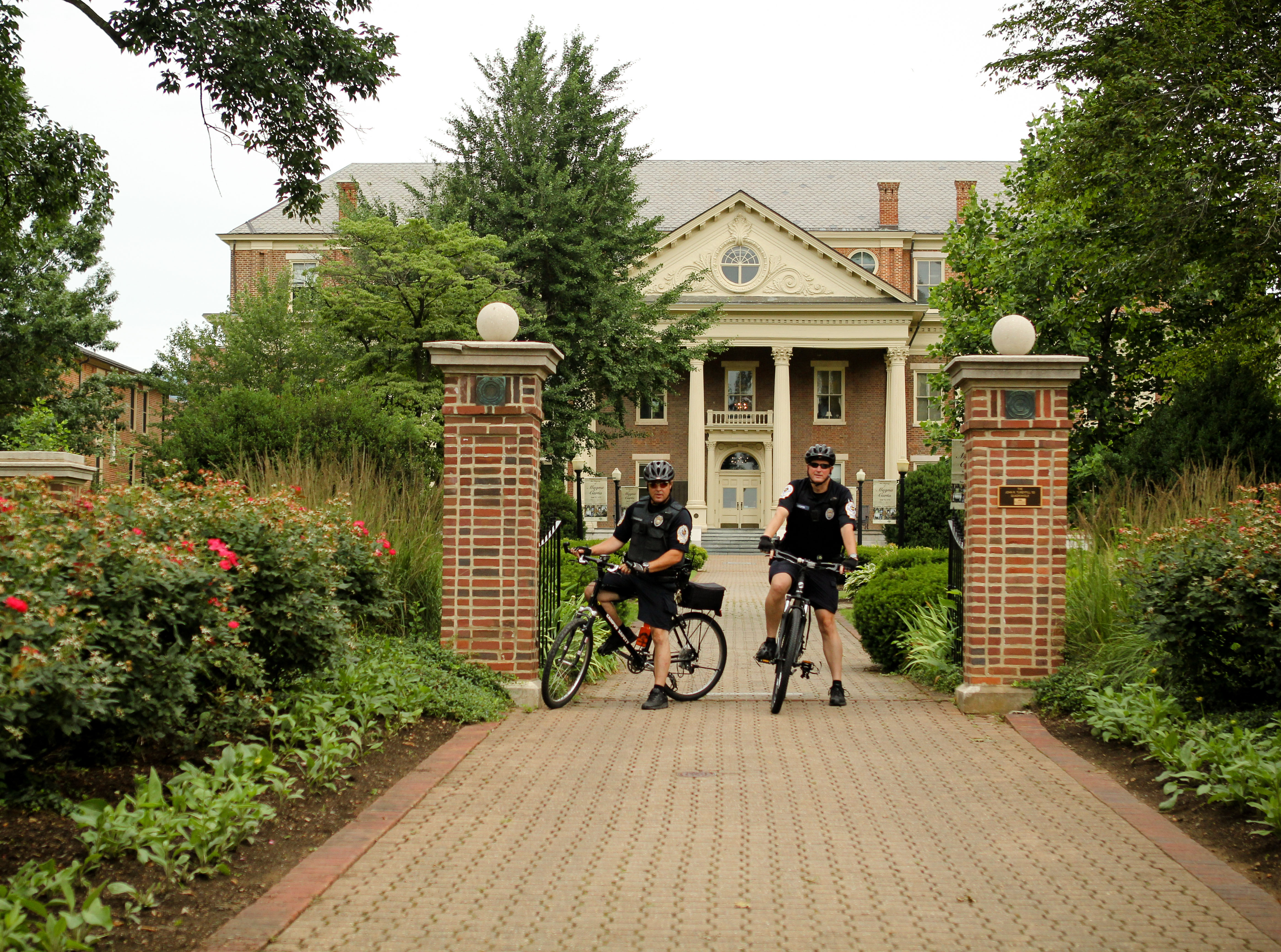 Campus Safety officers on bikes in front of the Administration Building
