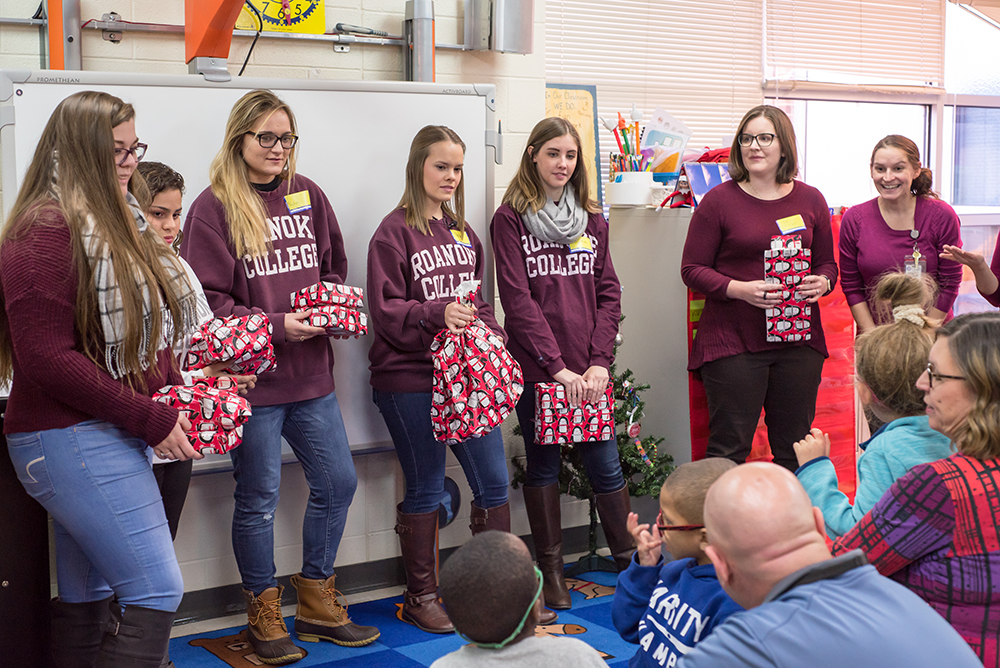 Roanoke College students in front of elementary school students