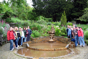 students by a fountain in a garden