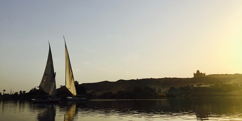 Two sailboats glide across the water