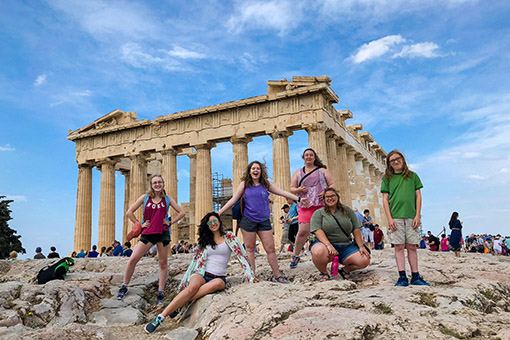 students posing in front of the Parthenon in Greece