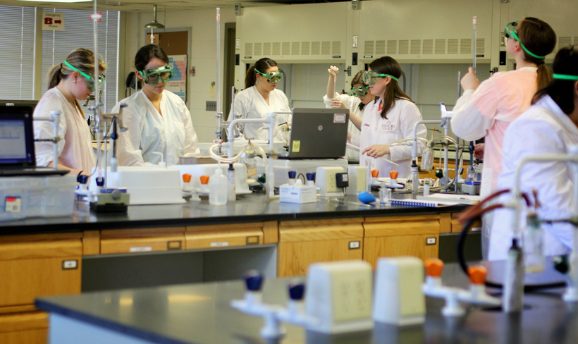 Several students in chemistry lab wearing googles