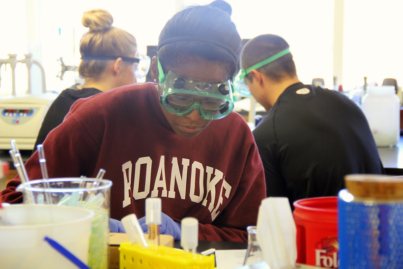 Student in chemistry lab wearing goggles