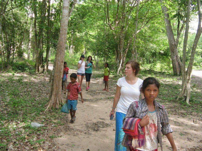 Students walking with children in Cambodia