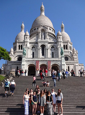 Students in just of a large building in France