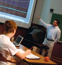 Students taking notes as a professor gives a lecture