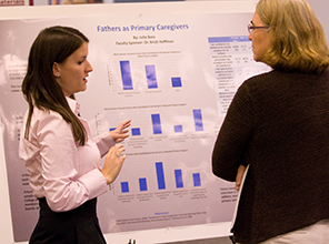 Julie Bass shares her work during a research poster presentation