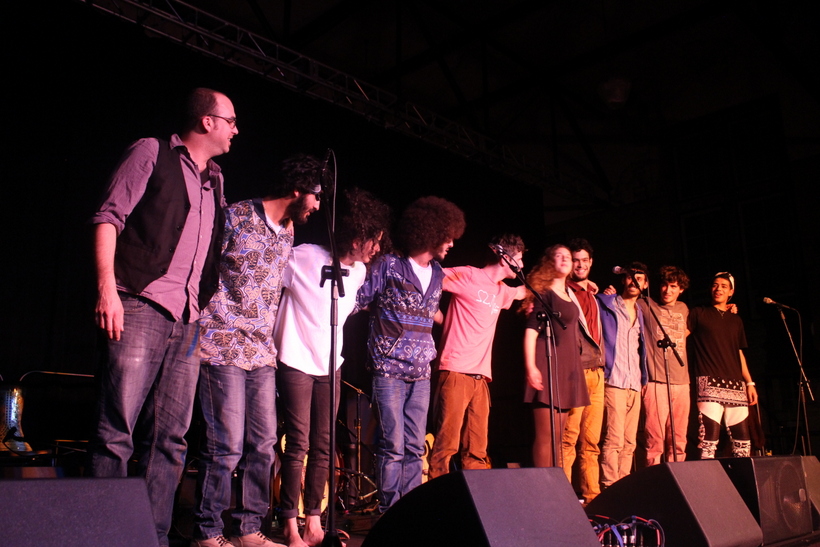 Students forming a chain on a stage