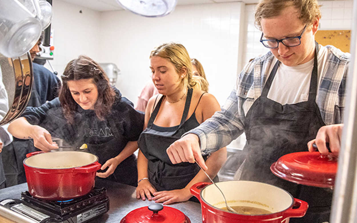 Students work over simmering pots