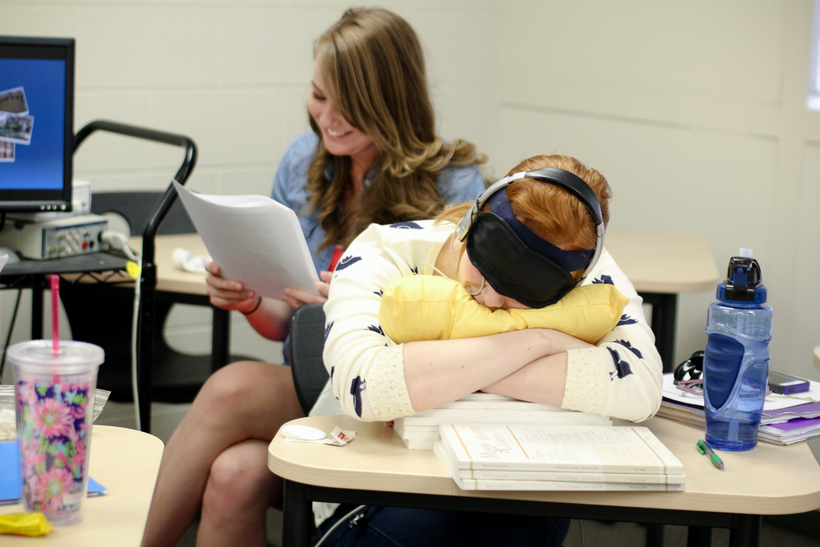 Student consulting notes during an experiment