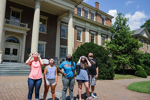 Students in front of Admin watching eclipse