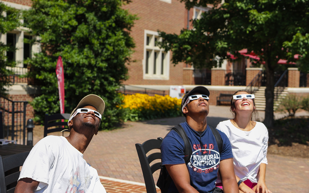 Students in front of Colket center watching eclipse