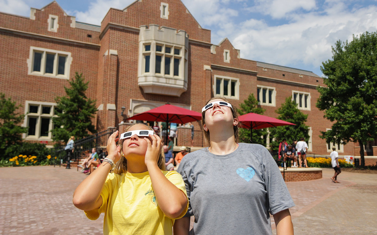 Students in front of Colket center watching eclipse