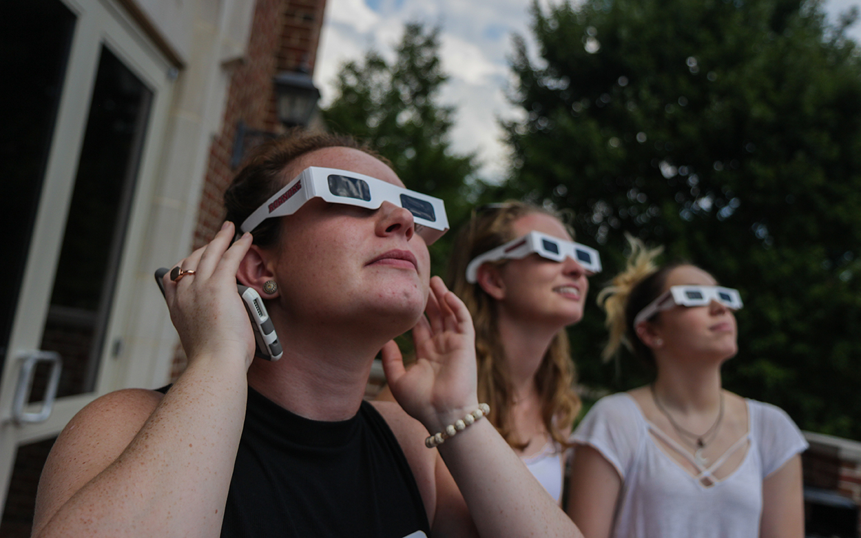 Students in front of Colket center watching eclipse