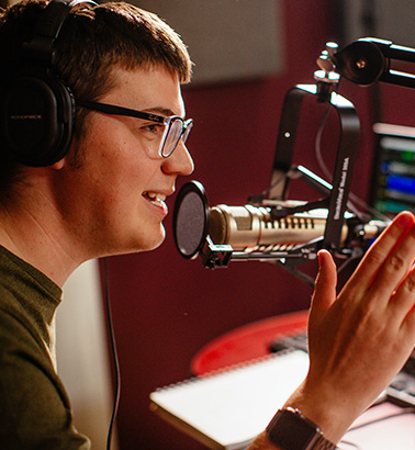 Elijah Wilhelm speaks into microphone as WRKE host